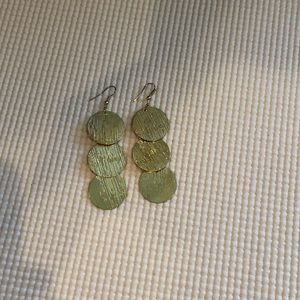 Long gold circle dangling earrings.